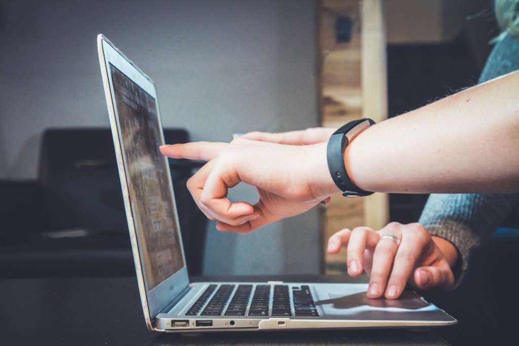 Two people working together at a laptop during a practical digital skills session