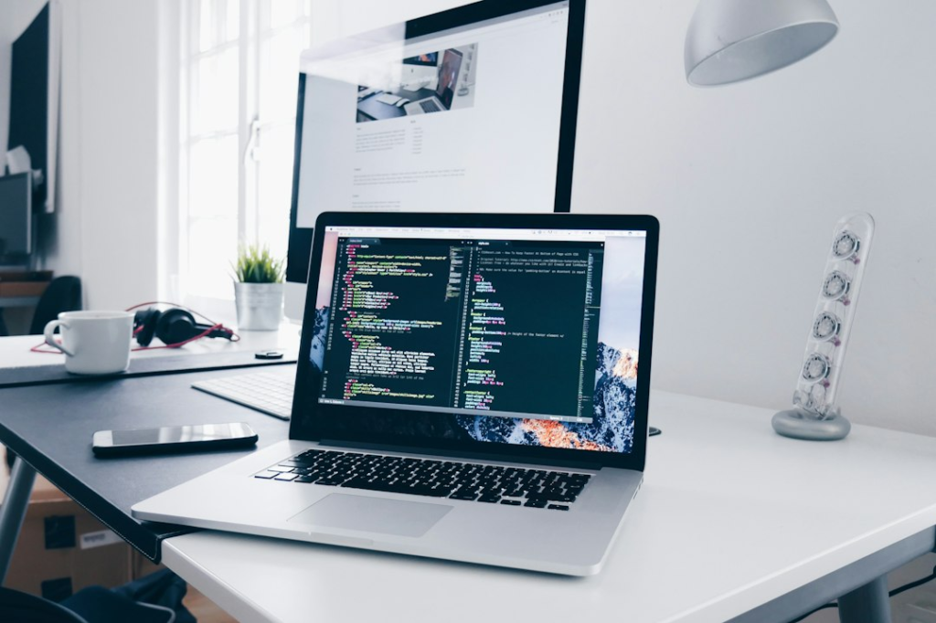 Laptop with code on screen, representing the design of a custom AI automation system